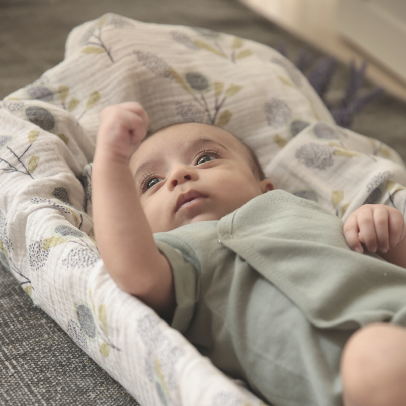 Swaddle is a light, breathable muslin wrap that mimics the feeling of being in the womb for a baby. It helps them feel safe and secure while they rest or sleep. Organic cotton organic muslin premium gift luxury gift sustainable clothes baby clothes baby gift newborn gift birthday gift onesie bodysuit