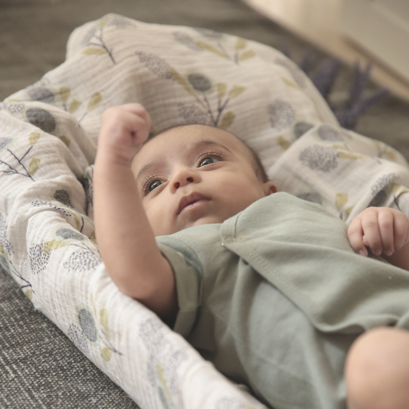 Swaddle is a light, breathable muslin wrap that mimics the feeling of being in the womb for a baby. It helps them feel safe and secure while they rest or sleep. Organic cotton organic muslin premium gift luxury gift sustainable clothes baby clothes baby gift newborn gift birthday gift onesie bodysuit