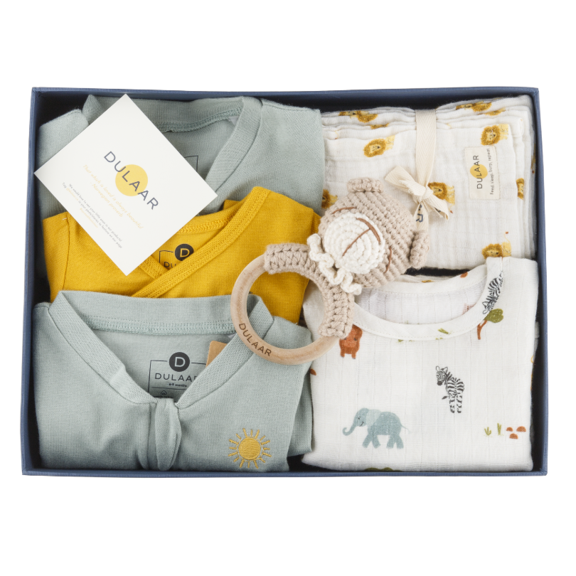 Image of a gift box filled with cute children toddler and baby clothes toys and newborn essentials Organic cotton organic muslin premium gift luxury gift sustainable clothes baby clothes baby gift newborn gift birthday gift onesie bodysuit