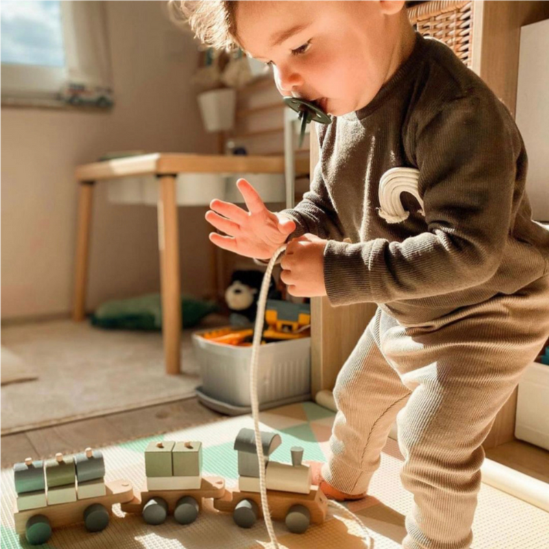 This beautiful wooden train offers a lot of hours of stacking fun. The toy helps develop and boost key skills like fine motor skills, hand-eye coordination, and encourages creativity in the assembling process. EU certified (EN-71), natural, non-toxic and eco-friendly Organic cotton organic muslin premium gift luxury gift sustainable clothes baby clothes baby gift newborn gift birthday gift onesie bodysuit